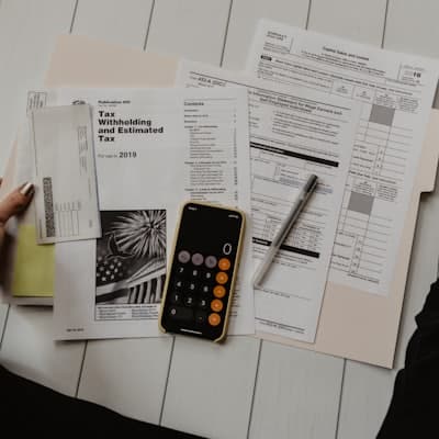 A calculator and notes beside cash